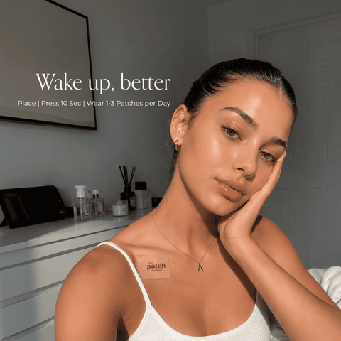 Woman applying or wearing a Glow Up patch in a lifestyle beauty setting