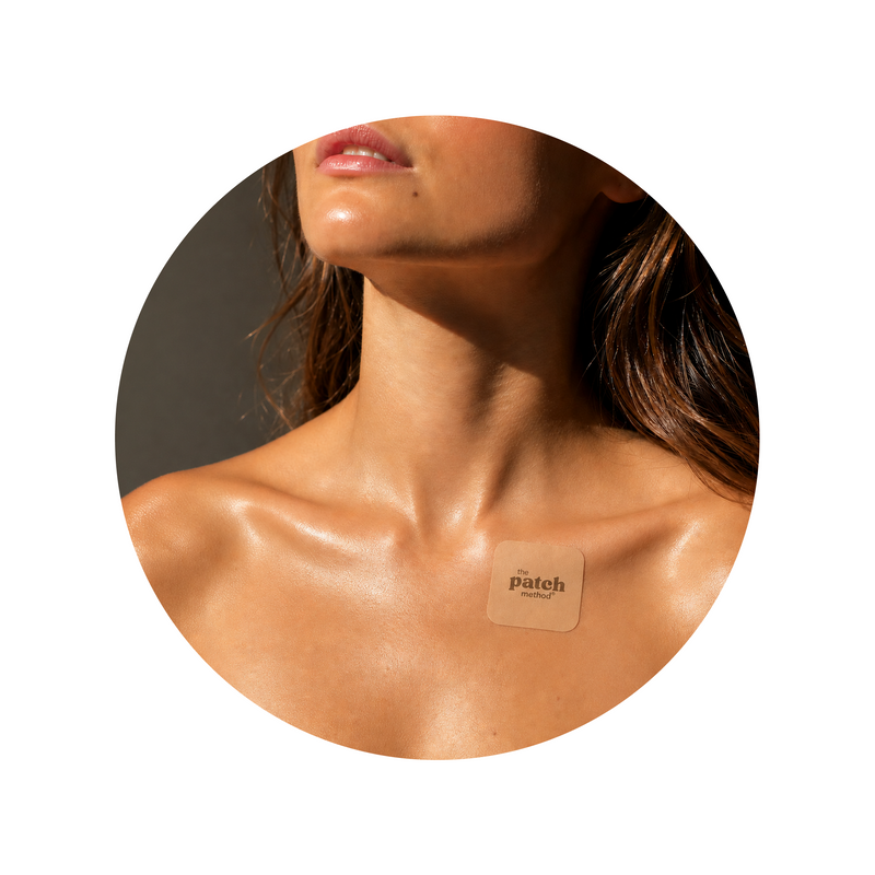 Woman wearing a The Patch Method wellness patch on her upper chest, representing mindset and thought work within The Lab personalized wellness program.