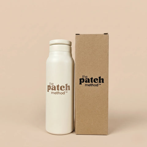 White bottle and brown box with 'the patch method' branding on a beige background