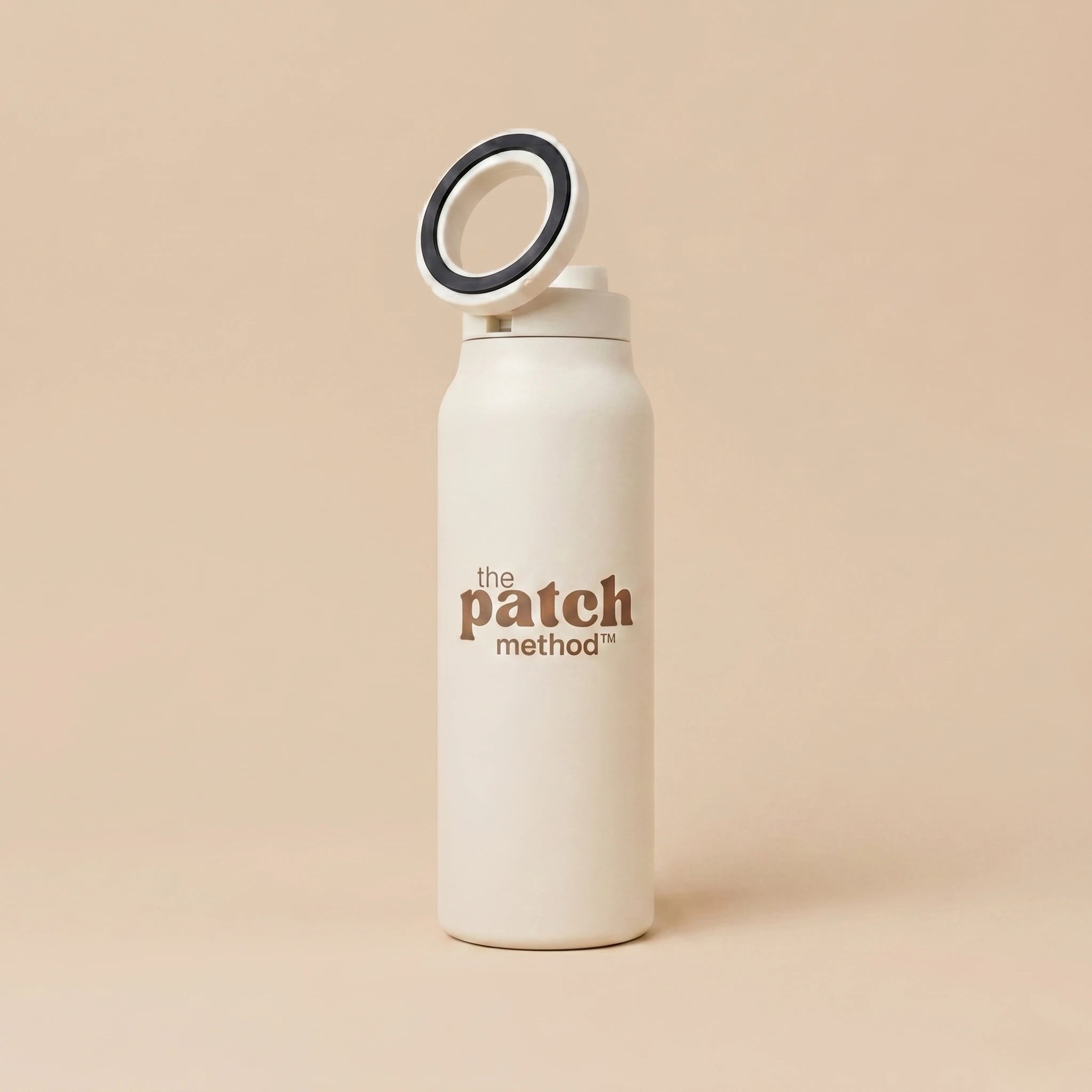 White water bottle with 'the patch method' branding on a beige background